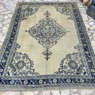 Blue 6' x 9' Turkish oushak rug in wool and cotton, shown on the floor.