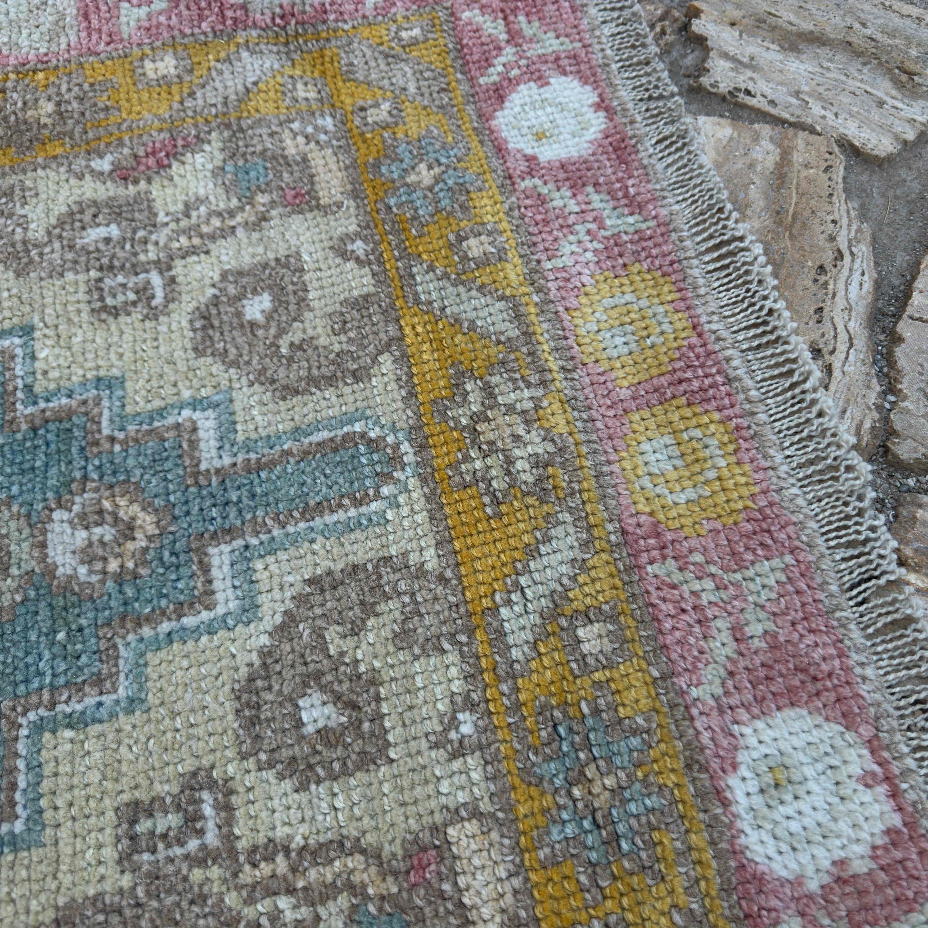 Close-up of the green Turkish oushak runner rug showing oushak details, hand-knotted weave, wool and cotton and low pile.