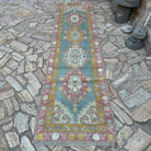 Green 3' x 11' Turkish oushak runner rug in wool and cotton, shown on the floor.