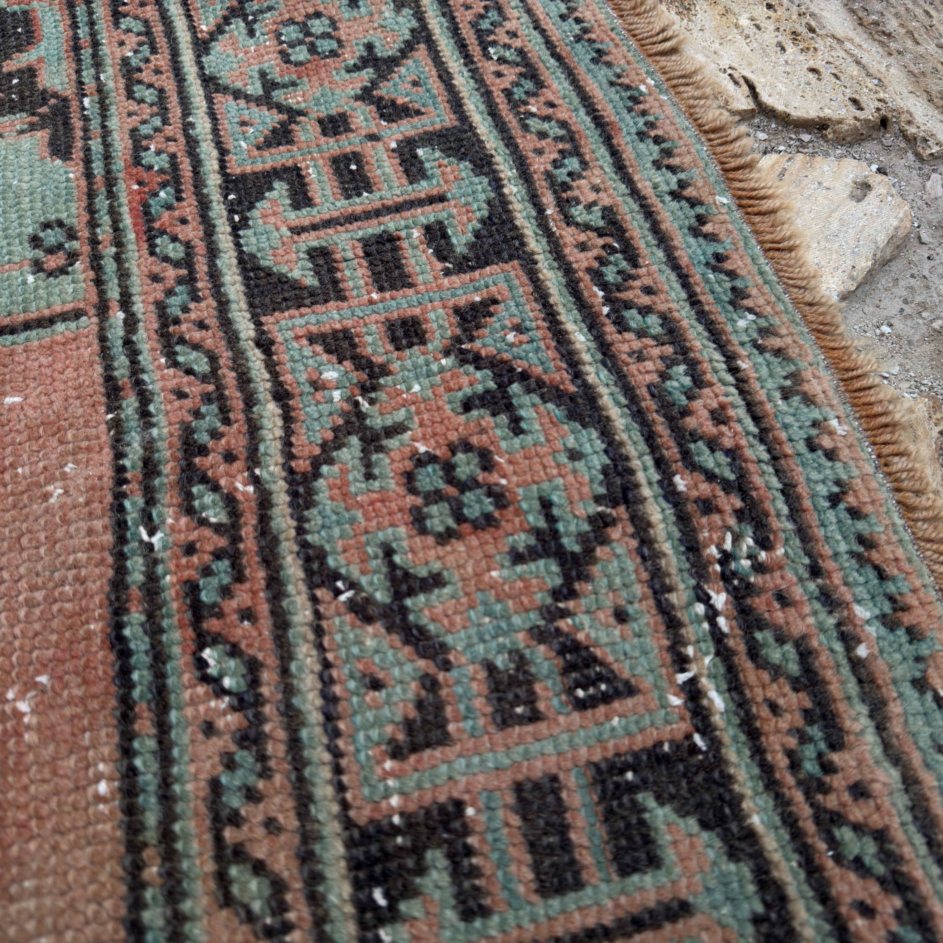 Close-up of the pale green Turkish oushak runner rug showing traditional details, hand-knotted weave, wool and cotton and low pile.