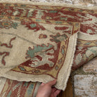 Close-up of the red Turkish oushak runner rug showing oushak details, hand-knotted weave, wool and low pile.