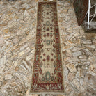 Red 3' x 14' Turkish oushak runner rug in wool, shown on the floor.