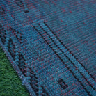 Green 2' x 4' Turkish overdyed mini rug in wool and cotton, shown on the floor.