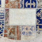 Close-up of the blue Turkish patchwork round rug showing patchwork details, hand-knotted weave, wool and cotton and low pile.
