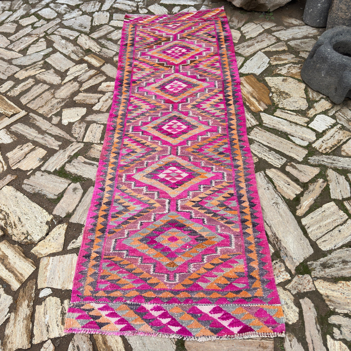 Pink 3' x 8' persian kilim runner rug in wool and cotton, shown on the floor.