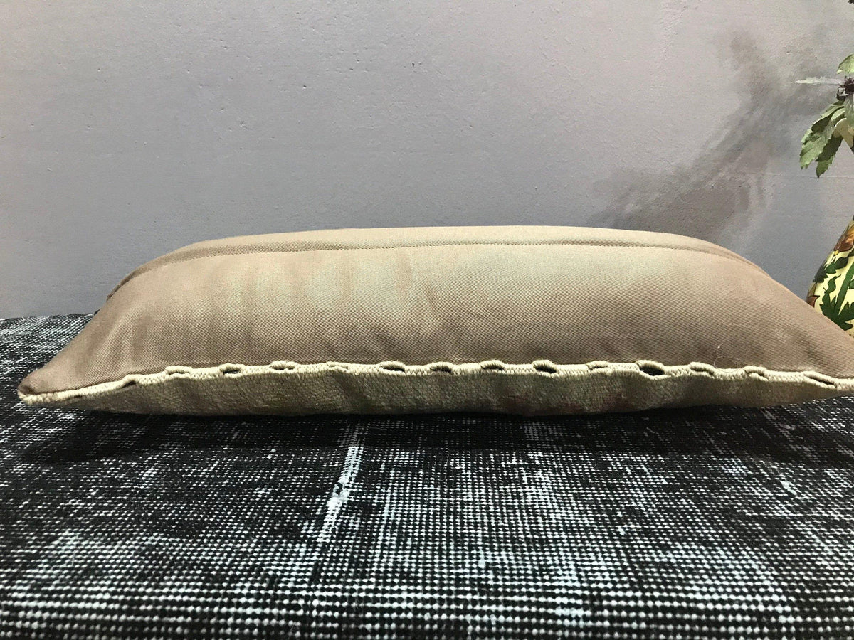 Colorful Turkish pillow cover, shown on the floor.