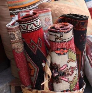 Vintage rug rolled face-in and wrapped in a cotton sheet for safe storage