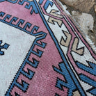 Close-up of the pink Turkish runner rug showing traditional details, hand-knotted weave, wool and cotton and low pile.