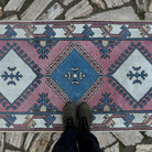 1970s pink Turkish runner rug with traditional design, hand-knotted weave and low pile.