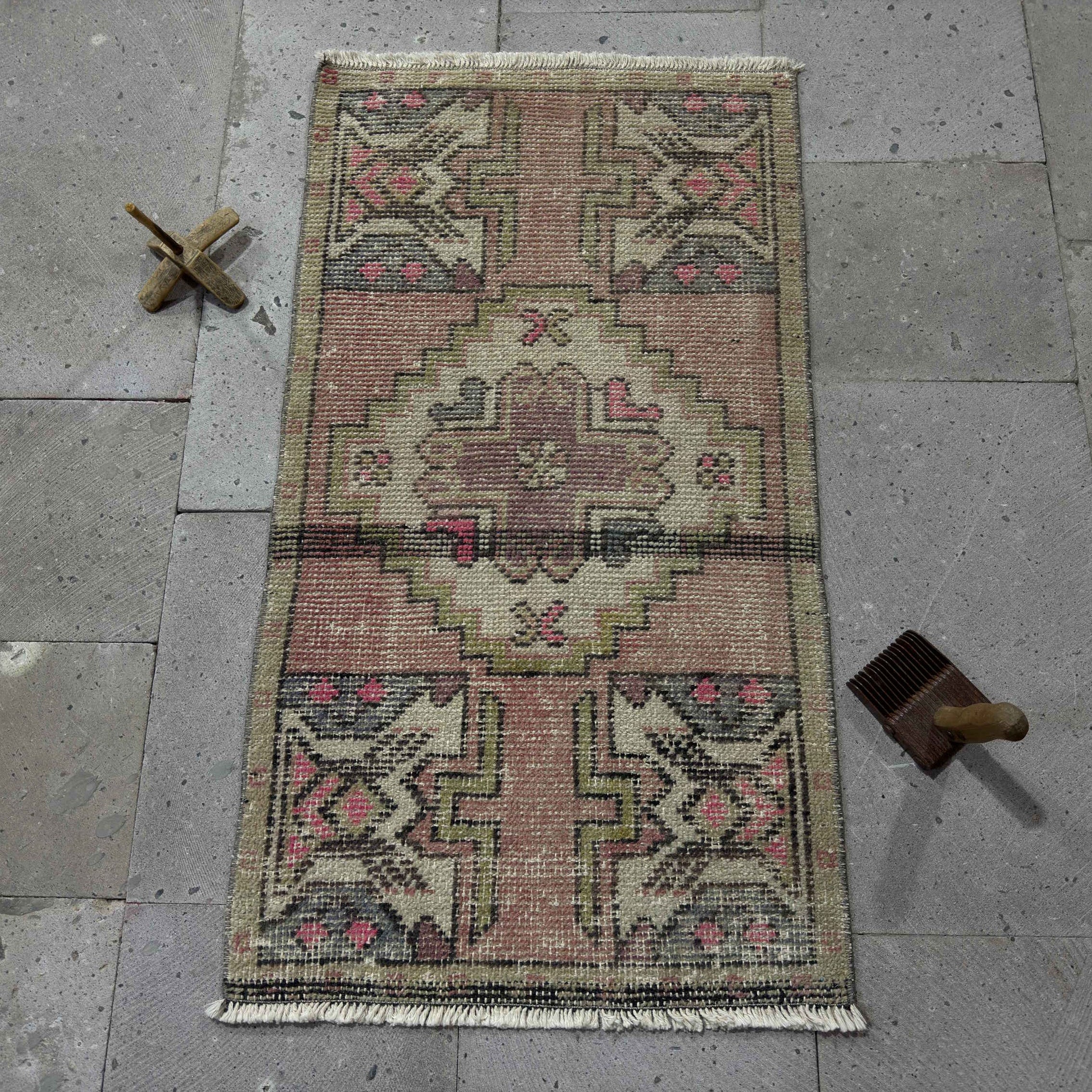 Pink 2' x 3' Turkish small anatolian rug in wool and cotton, shown on the floor.