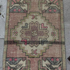 1970s pink Turkish small anatolian rug with traditional design, hand-knotted weave and low pile.