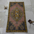 Red 2' x 3' Turkish small anatolian rug in wool and cotton, shown on the floor.