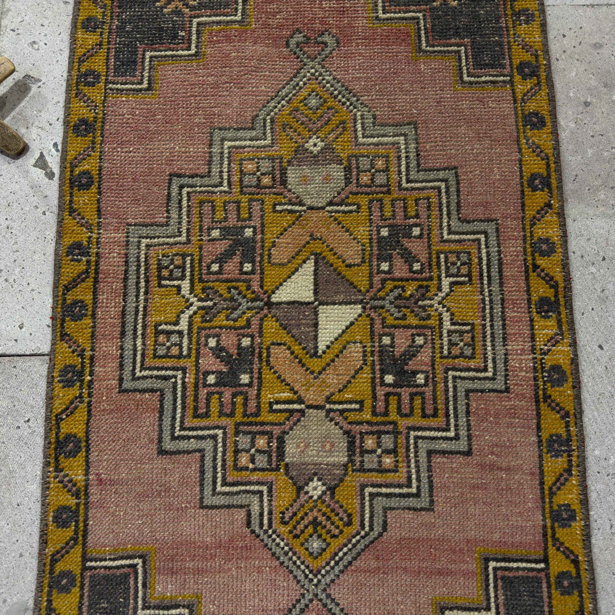 1970s red Turkish small anatolian rug with traditional design, hand-knotted weave and low pile.
