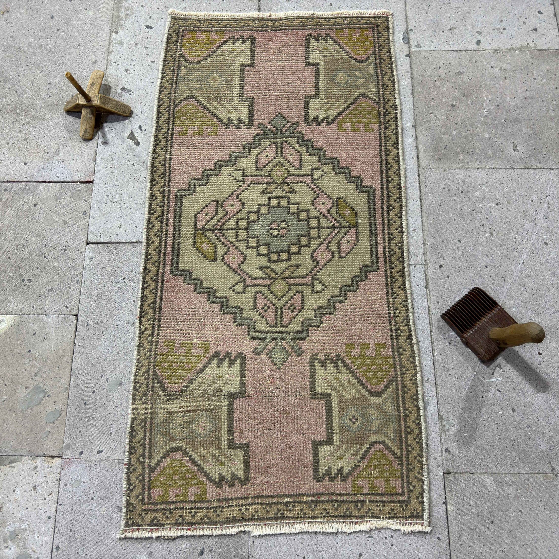 Pink 1' x 3' Turkish small area rug in wool and cotton, shown on the floor.