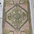1970s pink Turkish small area rug with traditional design, hand-knotted weave and low pile.