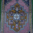 Close-up of the pink Turkish small area rug showing traditional details, hand-knotted weave, wool and cotton and low pile.