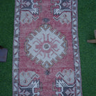 Close-up of the red Turkish small area rug showing traditional details, hand-knotted weave, wool and cotton and low pile.