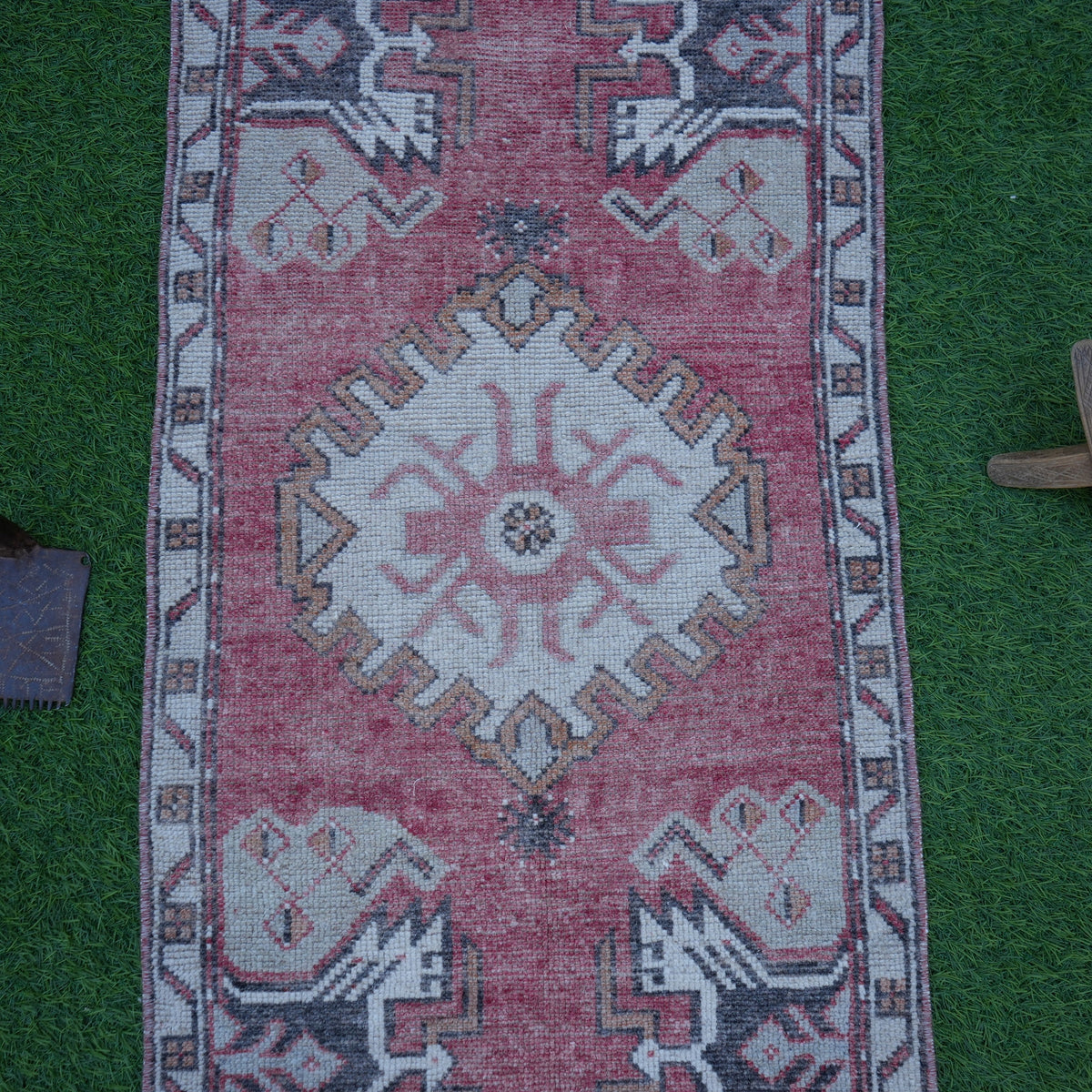 Close-up of the red Turkish small area rug showing traditional details, hand-knotted weave, wool and cotton and low pile.