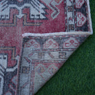 1970s red Turkish small area rug with traditional design, hand-knotted weave and low pile.