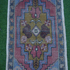 Close-up of the blue Turkish small handmade rug showing traditional details, hand-knotted weave, wool and cotton and low pile.