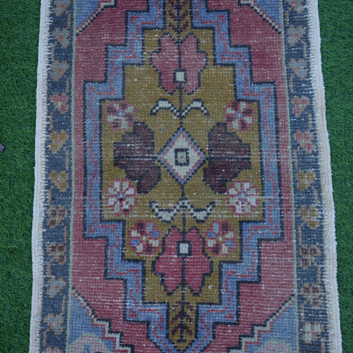 Close-up of the blue Turkish small handmade rug showing traditional details, hand-knotted weave, wool and cotton and low pile.