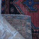 1970s red small persian rug with traditional design, hand-knotted weave and low pile.