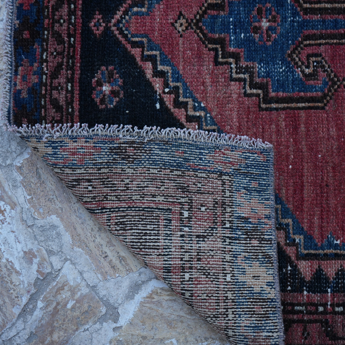1970s red small persian rug with traditional design, hand-knotted weave and low pile.