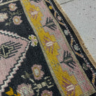 Close-up of the pink Turkish small runner rug showing traditional details, hand-knotted weave, wool and cotton and low pile.