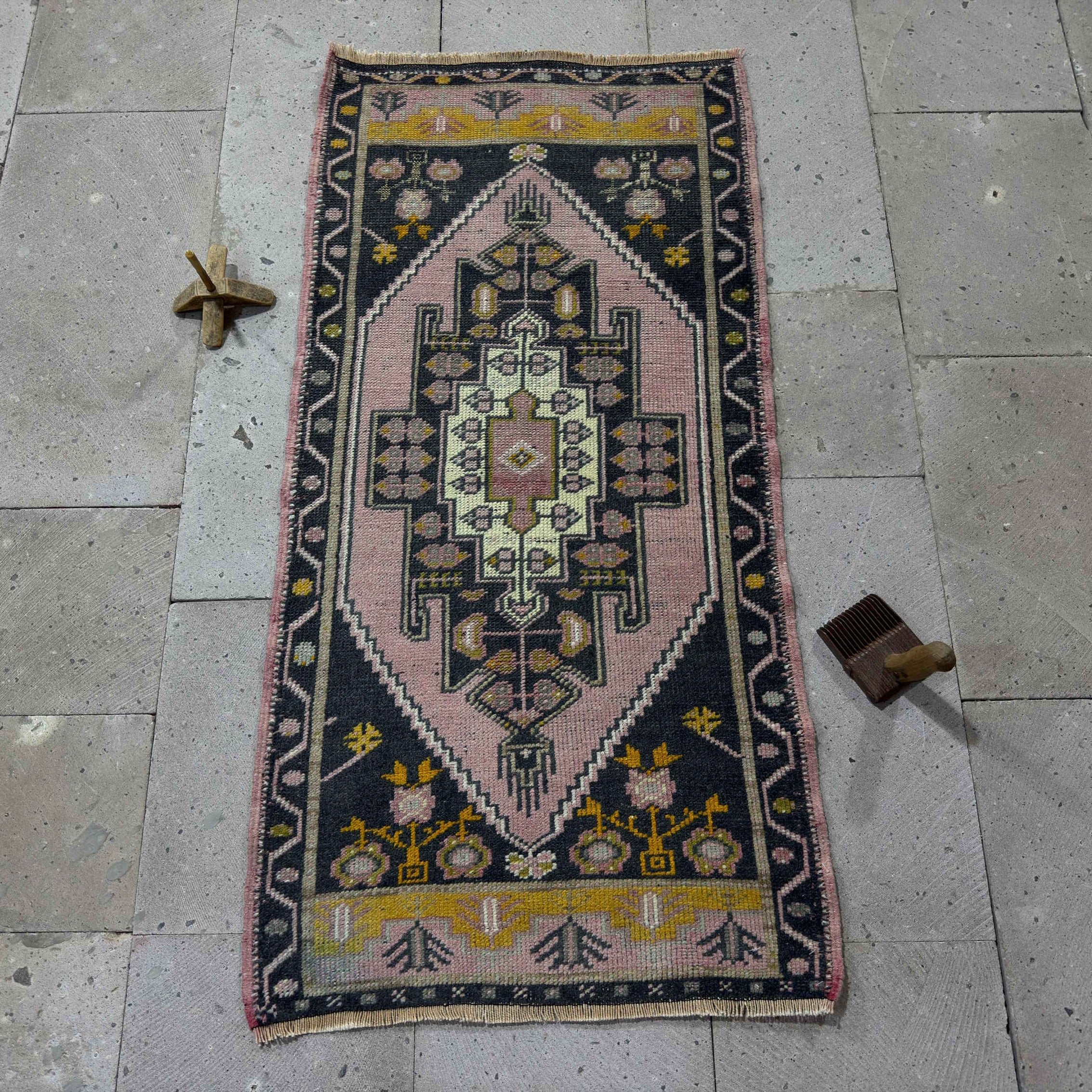 Pink 2' x 4' Turkish small runner rug in wool and cotton, shown on the floor.