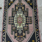 1970s pink Turkish small runner rug with traditional design, hand-knotted weave and low pile.