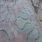 Close-up of the pink Turkish small runner rug showing traditional details, hand-knotted weave, wool and cotton and low pile.