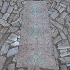 Pink 3' x 7' Turkish small runner rug in wool and cotton, shown on the floor.