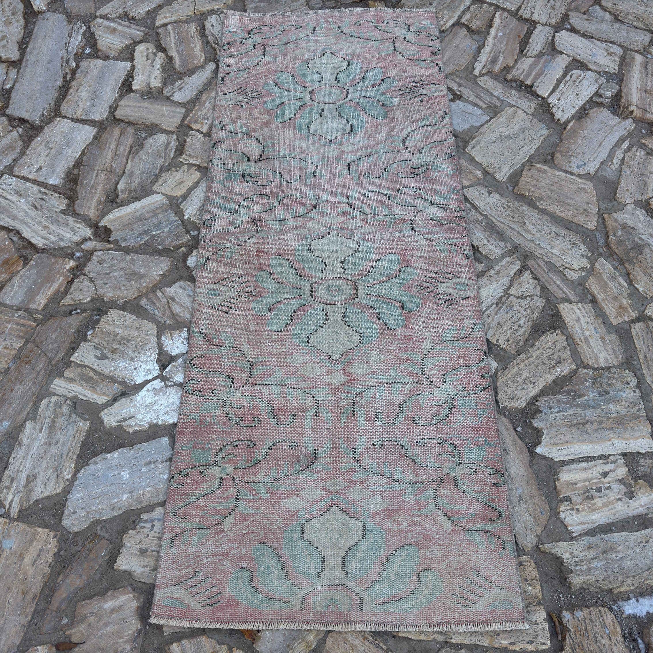Pink 3' x 7' Turkish small runner rug in wool and cotton, shown on the floor.
