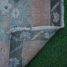 1970s pale orange Turkish small square rug with traditional design, hand-knotted weave and low pile.
