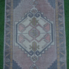 Close-up of the black small turkish rug showing traditional details, hand-knotted weave, wool and cotton and low pile.