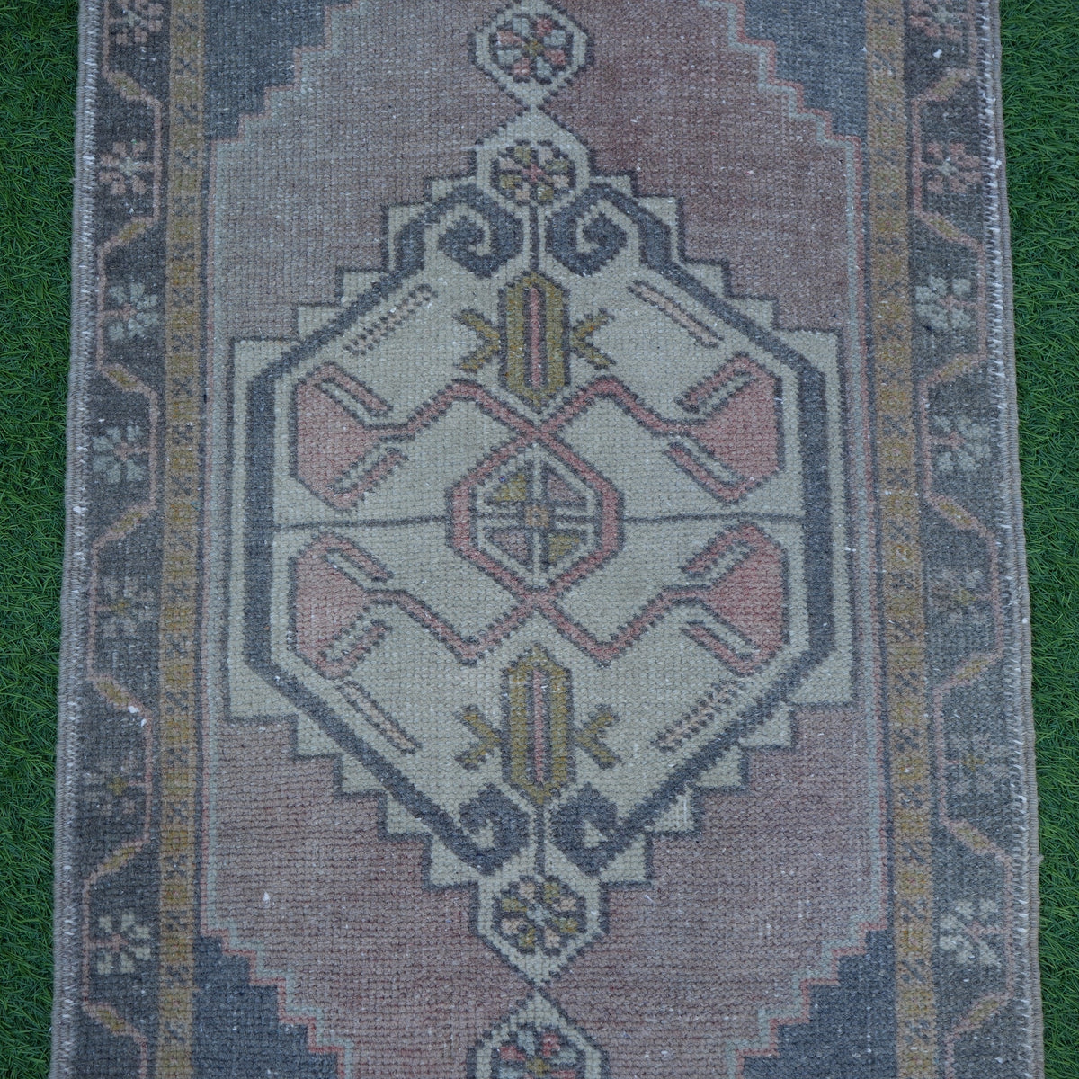 Close-up of the black small turkish rug showing traditional details, hand-knotted weave, wool and cotton and low pile.