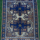Close-up of the blue small turkish rug showing traditional details, hand-knotted weave, wool and cotton and low pile.