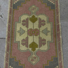 1970s pink small turkish rug with traditional design, hand-knotted weave and low pile.