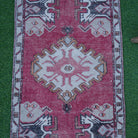 Close-up of the red small turkish rug showing traditional details, hand-knotted weave, wool and cotton and low pile.