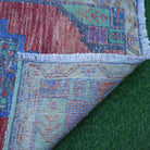 1970s red small turkish rug with traditional design, hand-knotted weave and low pile.
