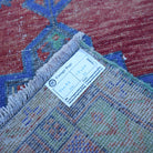 Red 2' x 3' small turkish rug from the 1970s with traditional design.