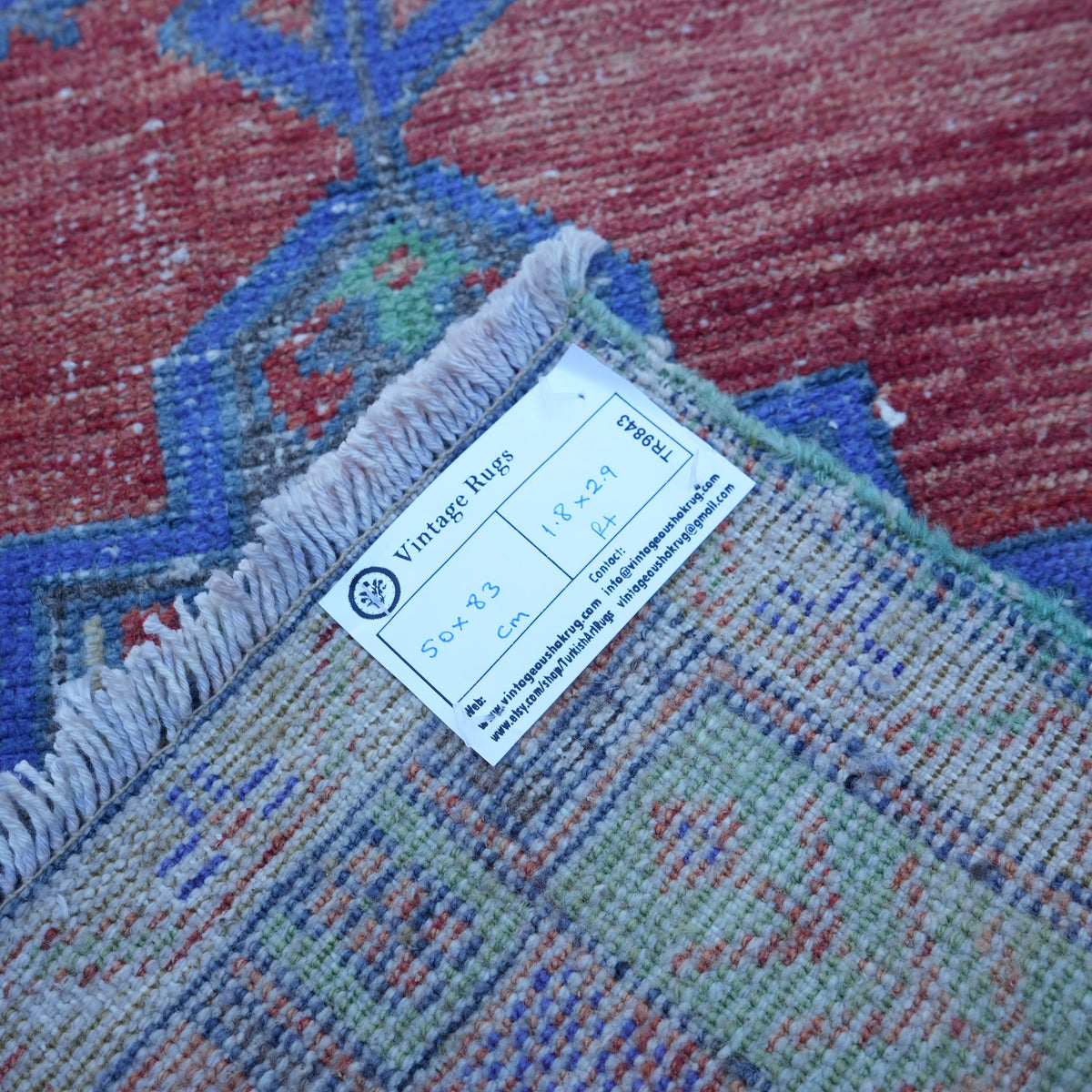 Red 2' x 3' small turkish rug from the 1970s with traditional design.