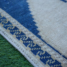 Blue 2' x 4' small turkish rug in wool, shown on the floor.