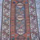 Close-up of the pale orange small turkish rug showing traditional details, hand-knotted weave, wool and low pile.