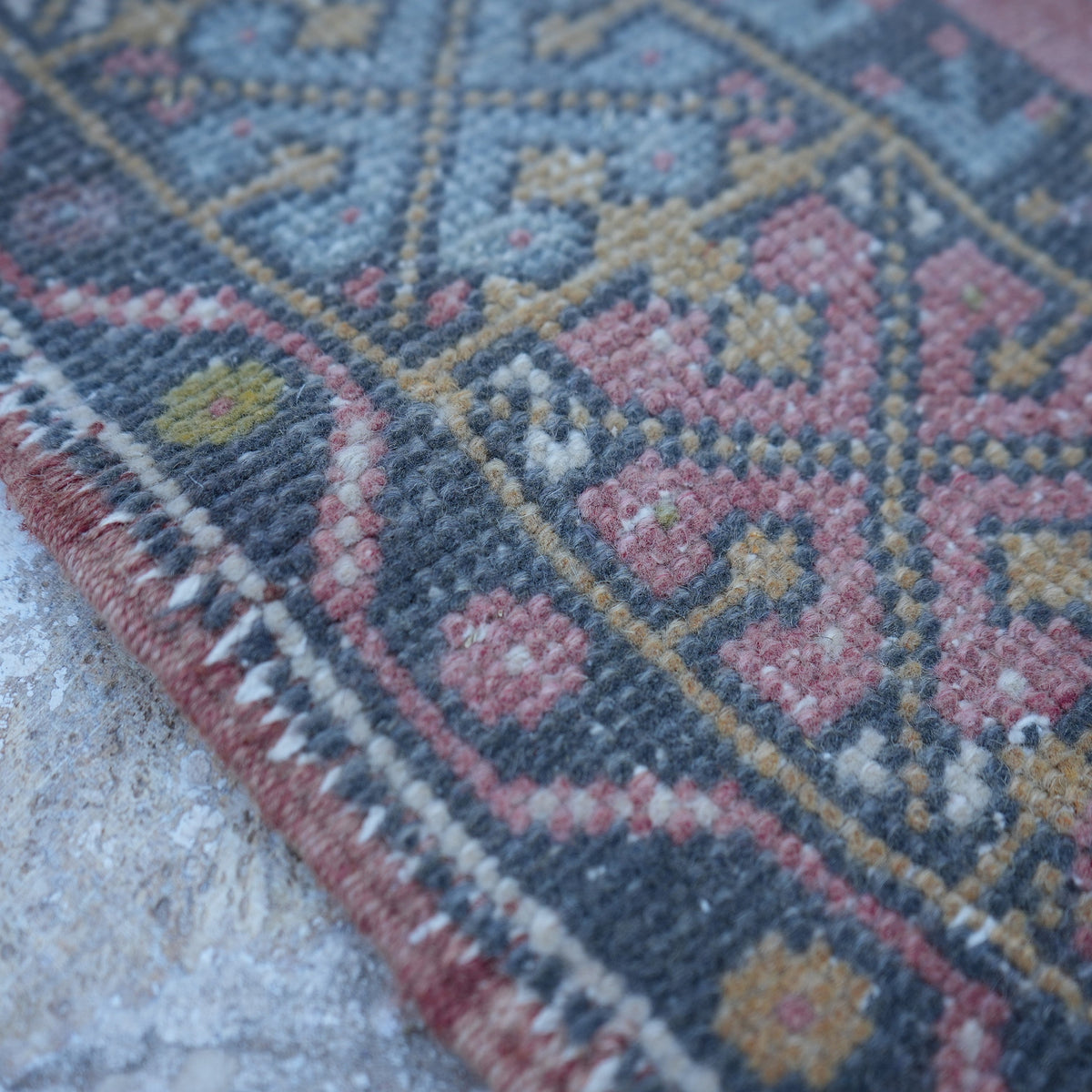 Pink 3' x 5' small turkish rug in wool, shown on the floor.