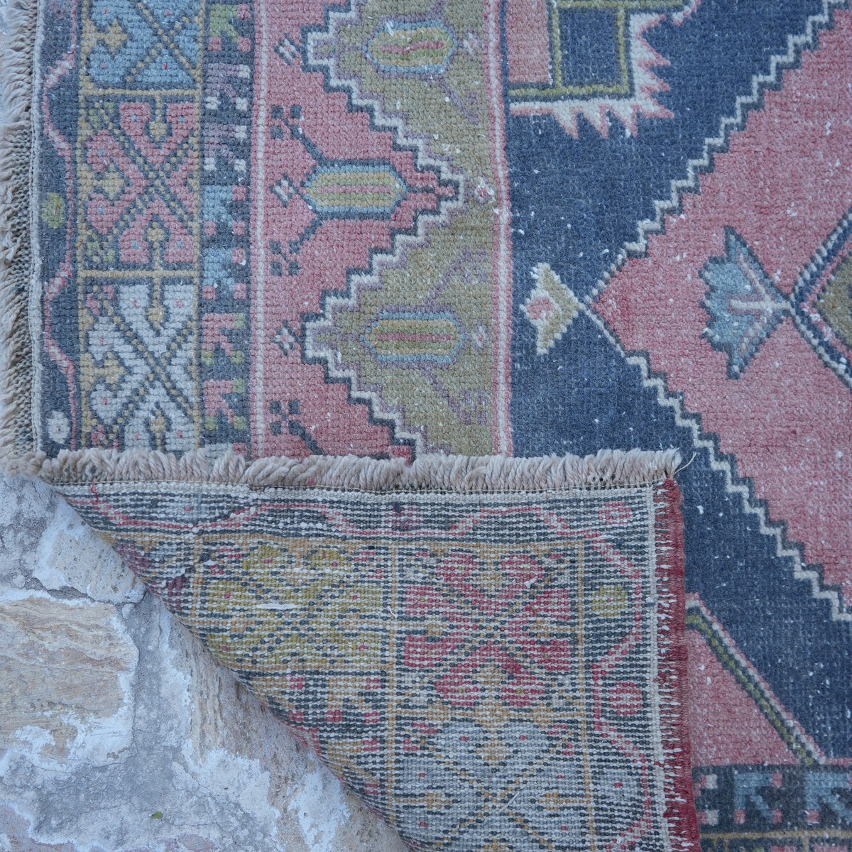 1970s pink small turkish rug with traditional design, hand-knotted weave and low pile.
