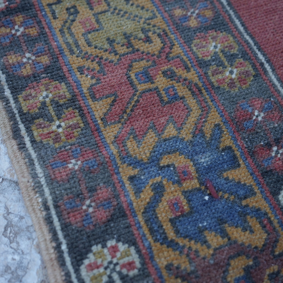 Red 4' x 6' small turkish rug in wool, shown on the floor.
