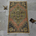 Pale Red 2' x 3' Turkish small vintage distressed rug in wool and cotton, shown on the floor.