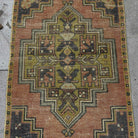 1970s pale red Turkish small vintage distressed rug with traditional design, hand-knotted weave and low pile.