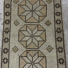 1970s beige Turkish small vintage geometric rug with neutral design, hand-knotted weave and low pile.
